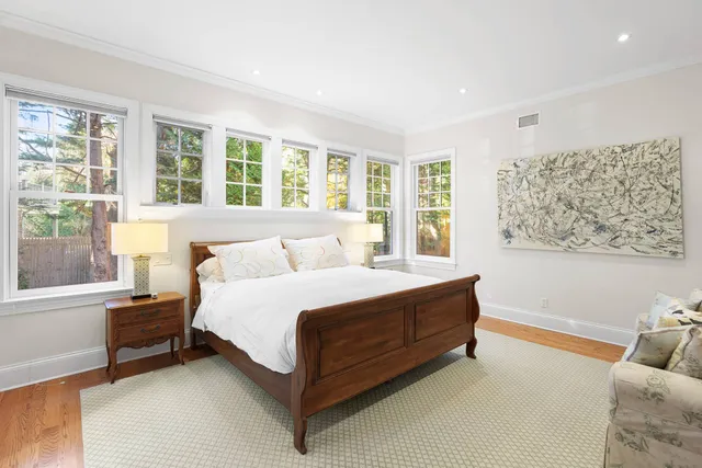 a spacious bedroom with a bed and a large window