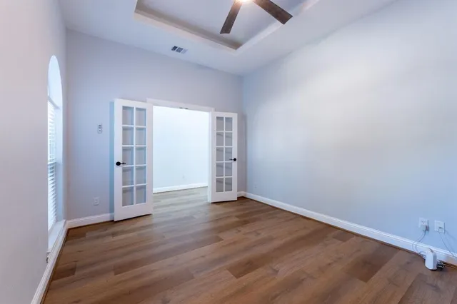 an empty room with wooden floor and closet