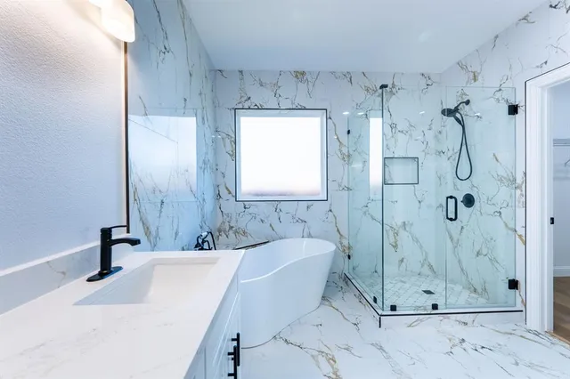 a bathroom with a tub sink and shower