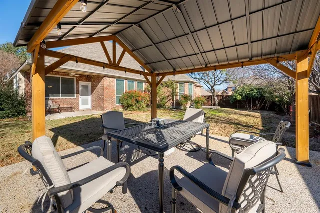 a view of a patio with a table and chairs
