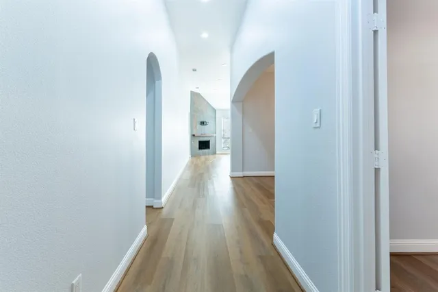 a view of a hallway with wooden floor