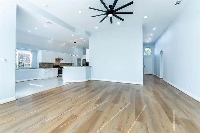 a view of a kitchen with a sink and a refrigerator