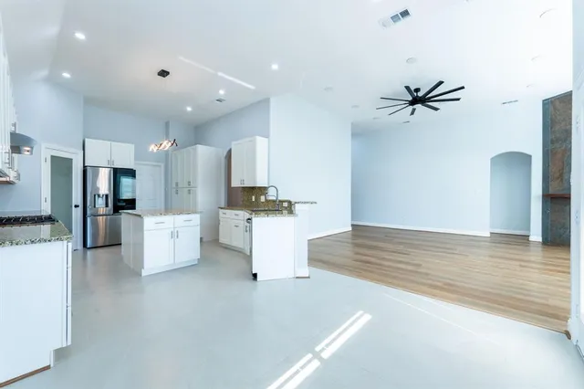 a view of kitchen with stainless steel appliances kitchen island a sink and a refrigerator