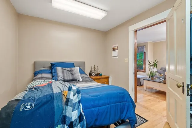 a bed sitting in a bedroom next to a window