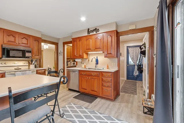 a kitchen with a refrigerator a stove top oven a sink and dishwasher