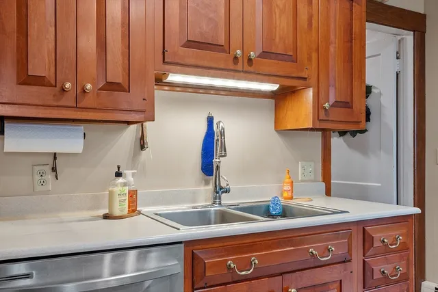a kitchen with stainless steel appliances granite countertop a sink and cabinets