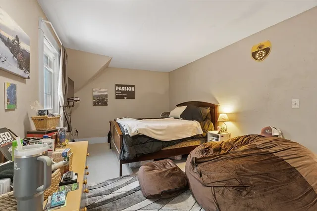 a bedroom with a bed furniture and a chandelier