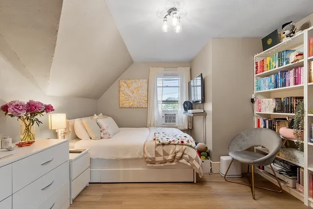 a bedroom with a bed and a window