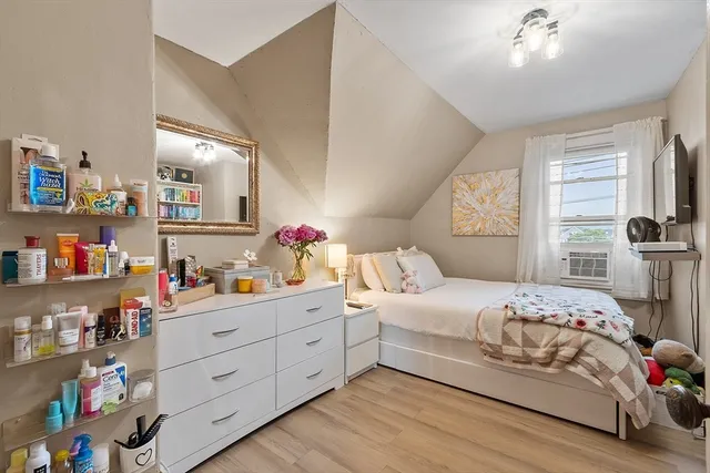 a bedroom with a bed and a television