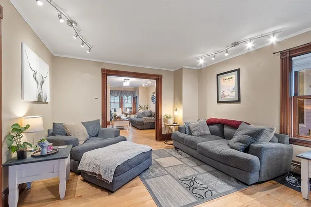 a living room with furniture and wooden floor