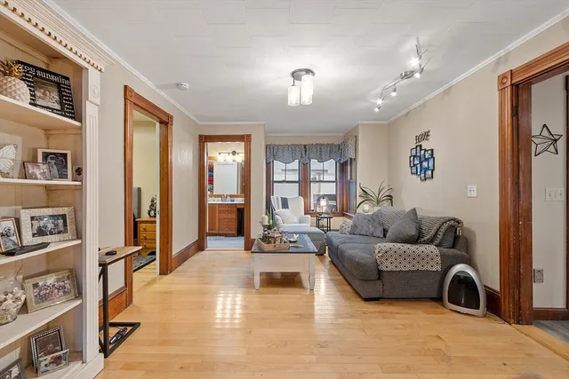 a living room with furniture window and wooden floor