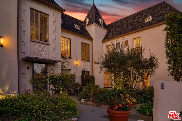 a view of a house with a flower garden