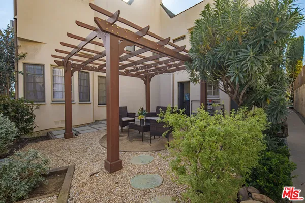 a view of a patio with table and chairs and potted plants