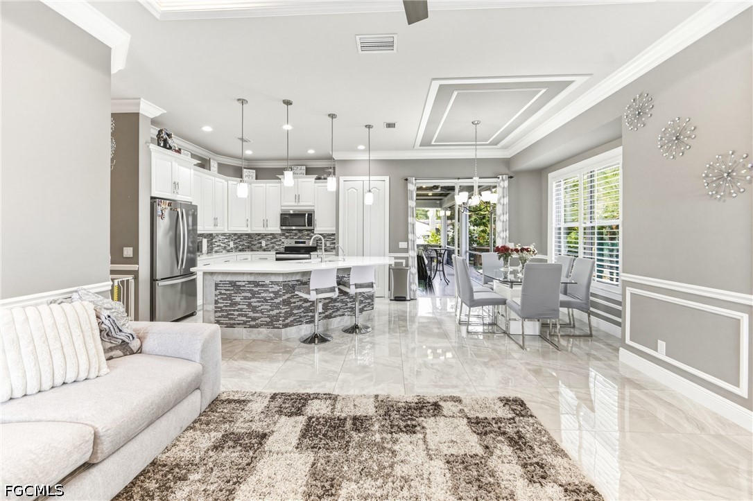1700 43rd Terrace Southwest Naples, FL 34116 - Photo 21 of 38 a view of a living room and dining room