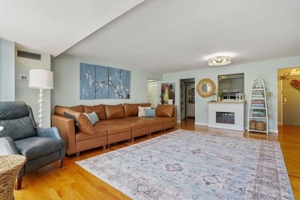 1 Commodore Court, Unit 104 Hull, MA 02045 - Photo 9 of 35 a living room with furniture and a fireplace