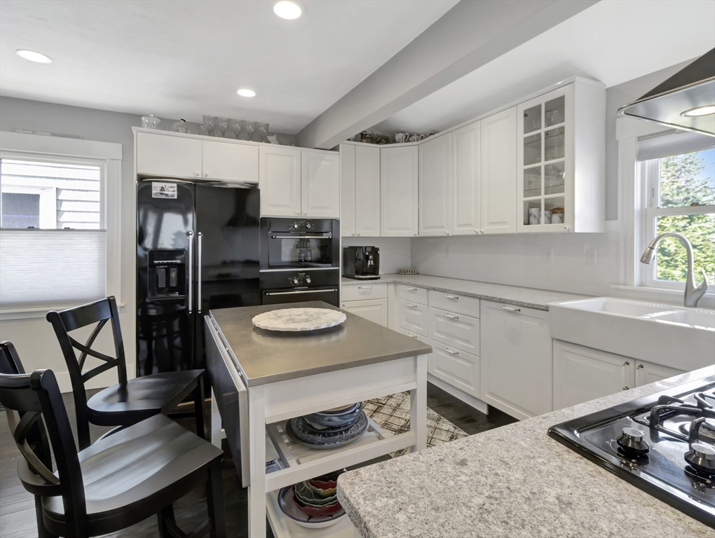 9 C Street Hull, MA 02045 - Photo 11 of 42 a kitchen with a stove a sink and a refrigerator