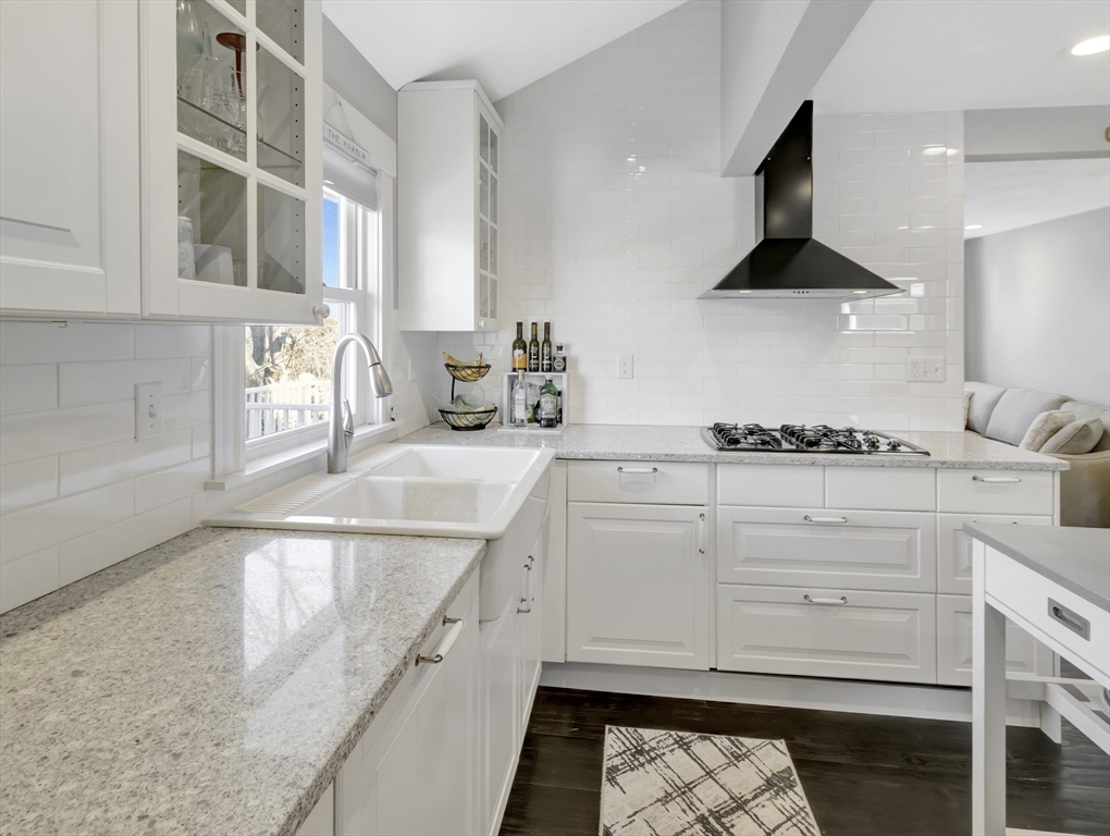 9 C Street Hull, MA 02045 - Photo 12 of 42 a kitchen with stainless steel appliances granite countertop a sink and a stove