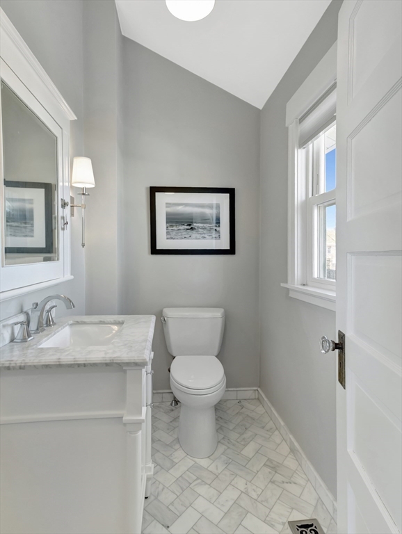 9 C Street Hull, MA 02045 - Photo 15 of 42 a bathroom with a granite countertop toilet a mirror and a sink