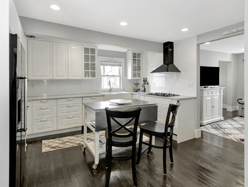 9 C Street Hull, MA 02045 - Photo 8 of 42 a kitchen with a table chairs sink and cabinets