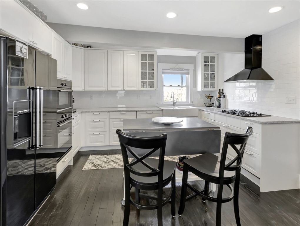 9 C Street Hull, MA 02045 - Photo 9 of 42 a kitchen with a table chairs stove and refrigerator
