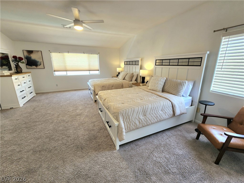 2743 Peekskill Avenue Henderson, NV 89052 - Photo 24 of 51 This spacious bedroom offers comfortable carpeting and natural light, creating a serene and inviting atmosphere.