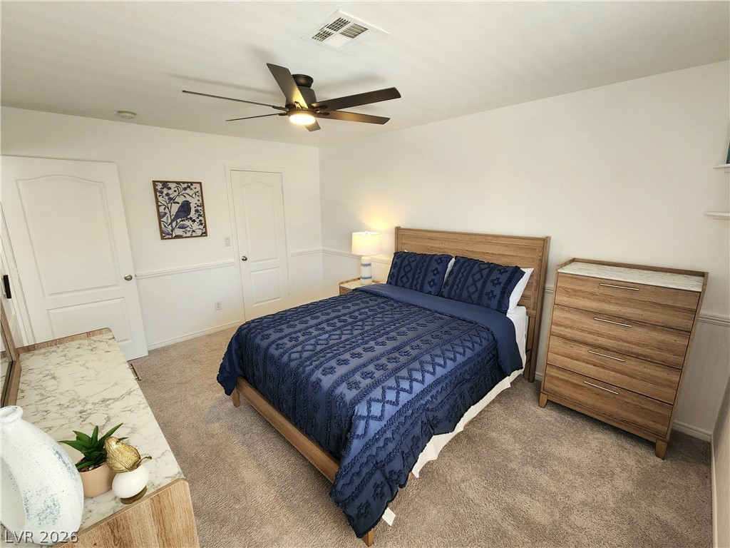 2743 Peekskill Avenue Henderson, NV 89052 - Photo 31 of 51 Bright bedroom with warm natural light and textured carpeting, ideal for serene relaxation.