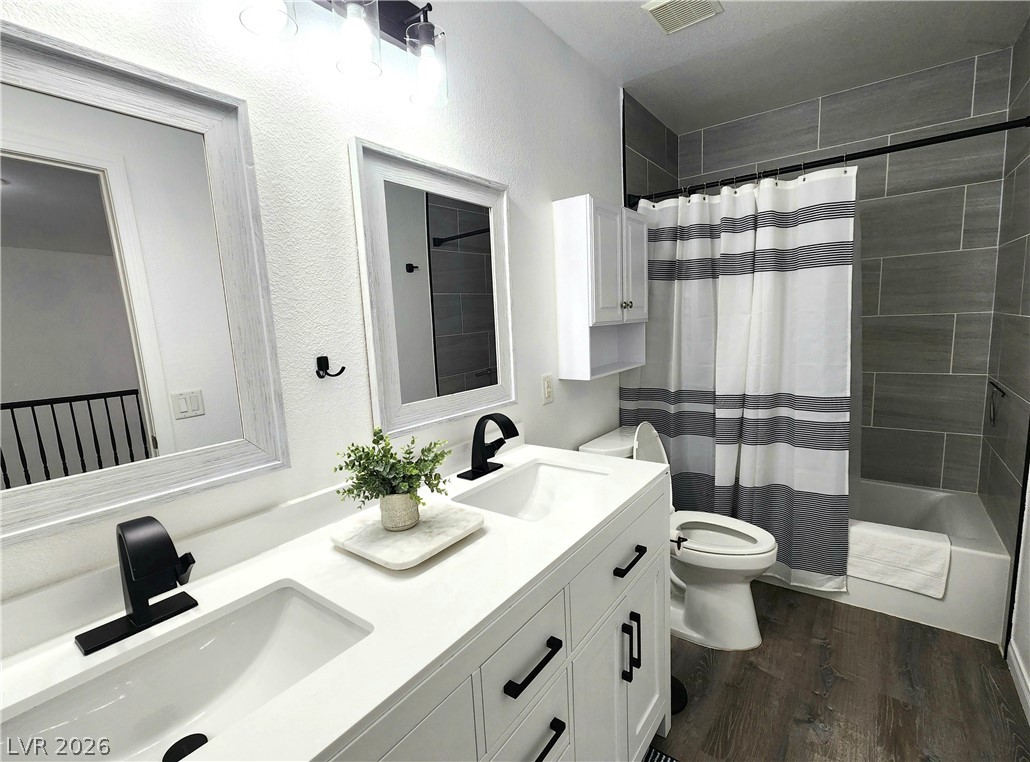 2743 Peekskill Avenue Henderson, NV 89052 - Photo 37 of 51 This modern bathroom offers dual vanities and a sleek tiled shower, providing comfort and contemporary style.