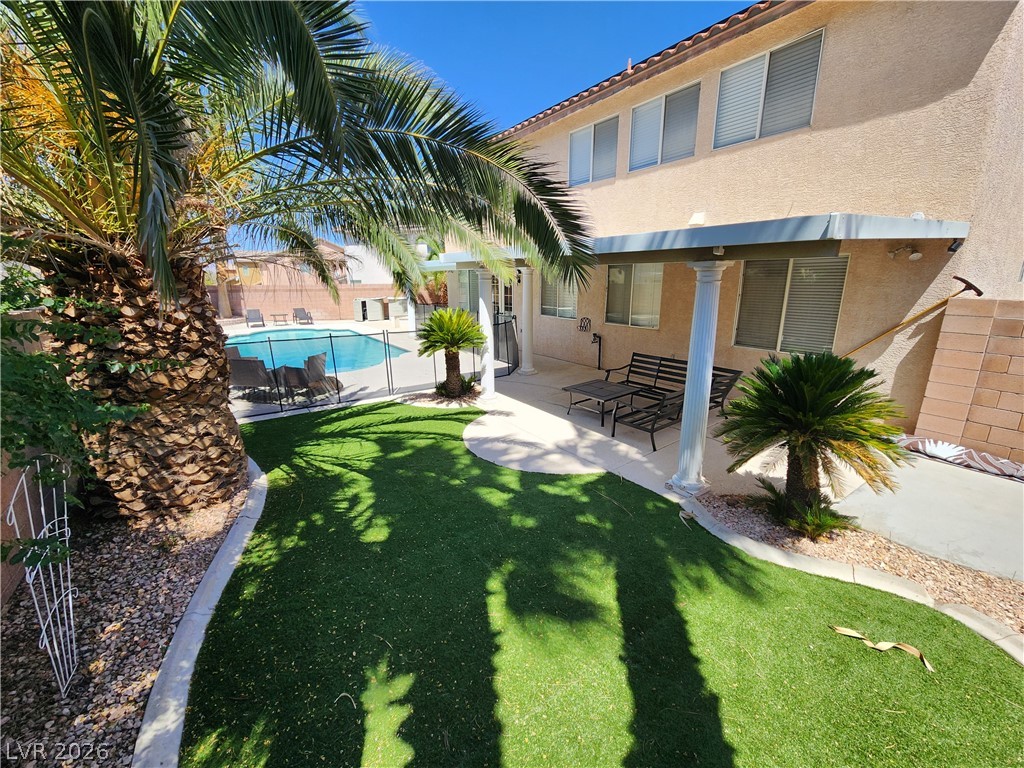 2743 Peekskill Avenue Henderson, NV 89052 - Photo 43 of 51 This private yard features a sparkling pool, lush artificial turf, and a covered patio perfect for outdoor enjoyment.