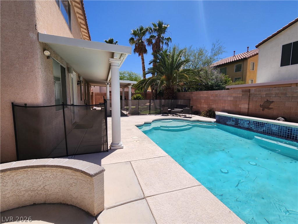 2743 Peekskill Avenue Henderson, NV 89052 - Photo 46 of 51 This outdoor oasis features a refreshing pool, inviting patio, and lush palm trees.