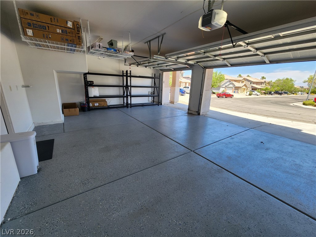 2743 Peekskill Avenue Henderson, NV 89052 - Photo 49 of 51 This spacious garage offers practical storage solutions with an open door to the inviting neighborhood.