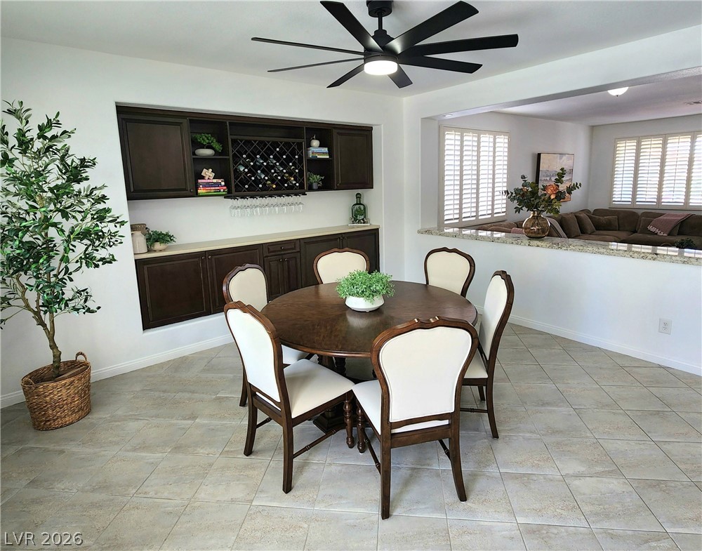 2743 Peekskill Avenue Henderson, NV 89052 - Photo 9 of 51 This inviting dining area features a built-in dry bar and tile flooring, perfect for entertaining.