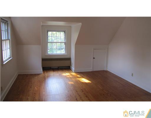 127 Washington Road Princeton, NJ 08540 - Photo 8 of 11 a open hall with a floor to ceiling window and wooden floor