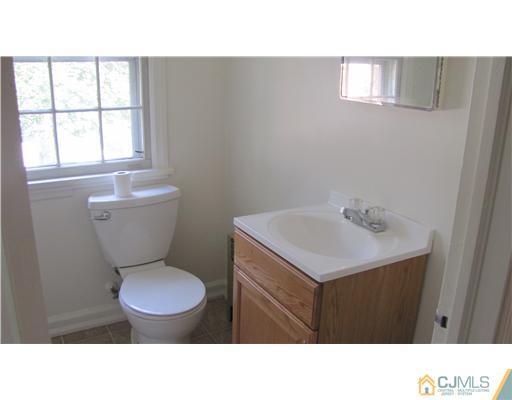 127 Washington Road Princeton, NJ 08540 - Photo 9 of 11 a bathroom with a sink mirror vanity and a toilet