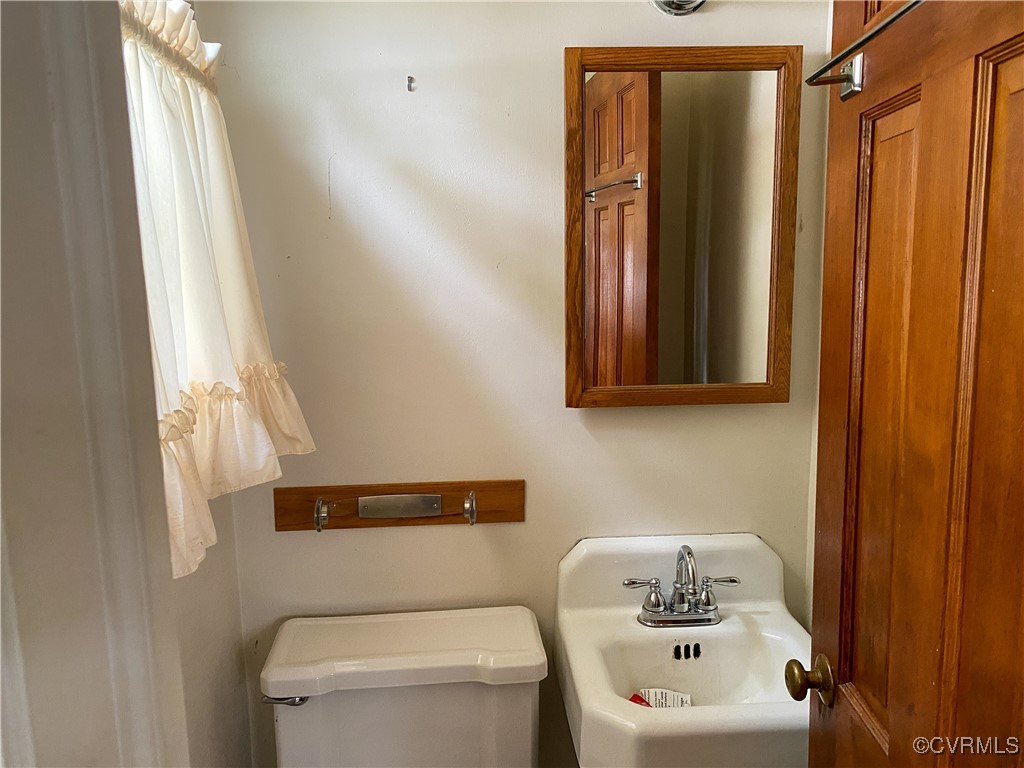 213 Jade Road Richmond, VA 23236 - Photo 12 of 33 a bathroom with a sink a toilet and shower curtain