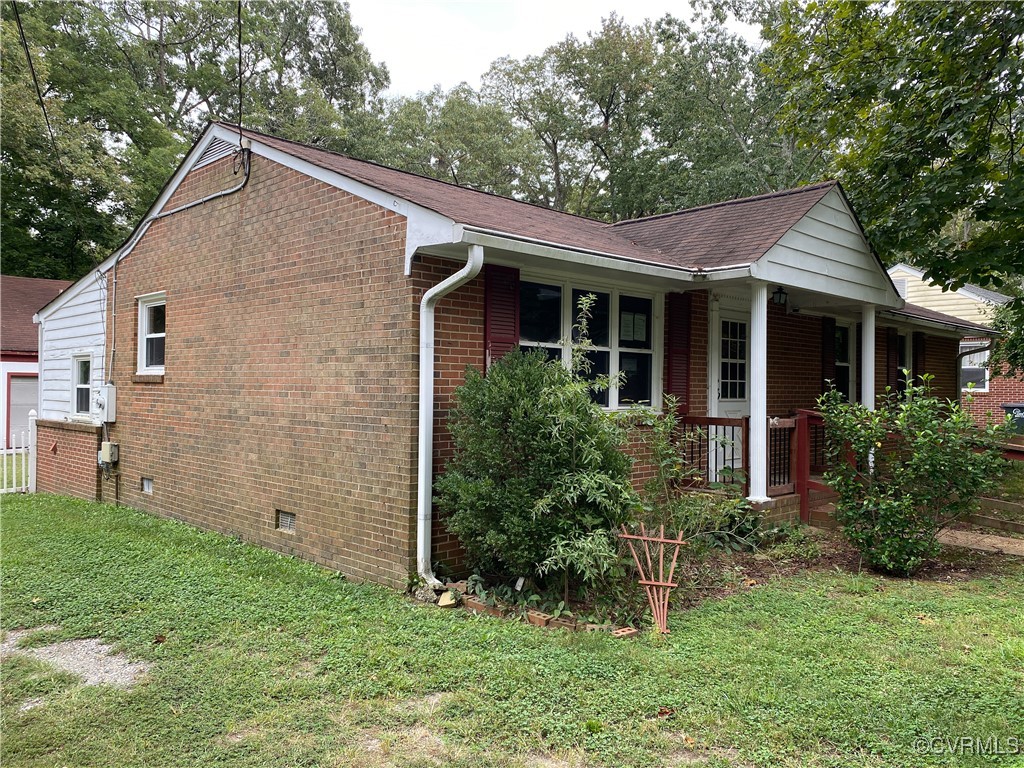 213 Jade Road Richmond, VA 23236 - Photo 3 of 33 a view of a house with brick walls and a yard with plants and large trees