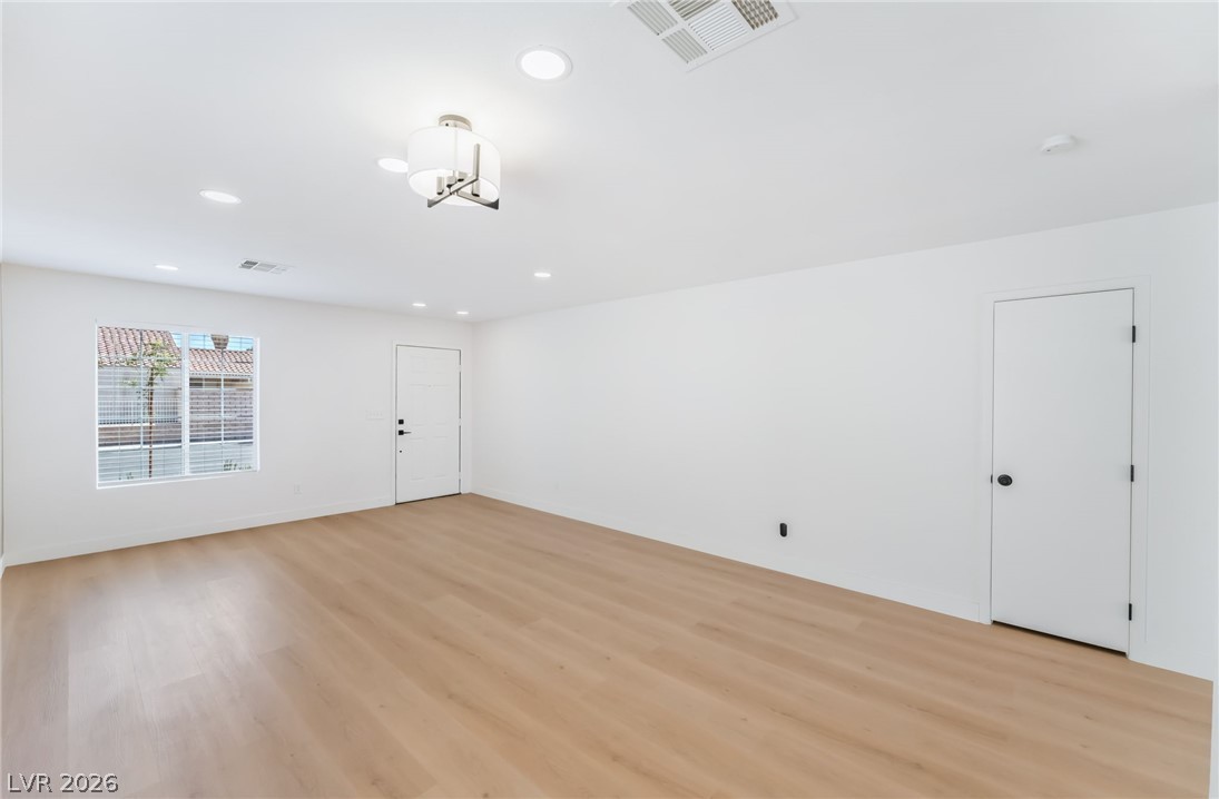 668 Rising Brook Drive Henderson, NV 89011 - Photo 4 of 22 Natural light pours into this bright space, featuring light hardwood floors and recessed lighting throughout.