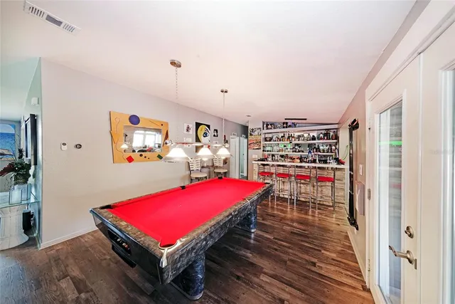 a room with pool table and flat screen tv
