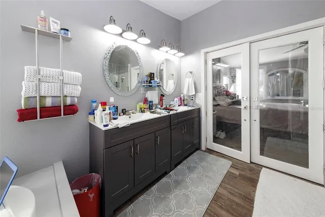a bathroom with a sink vanity mirror and toilet