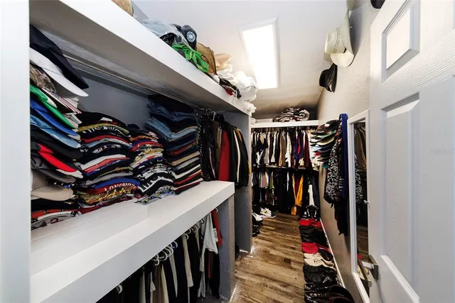 a spacious bedroom with a bed and a chandelier