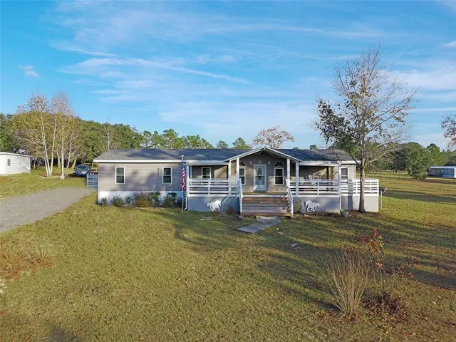 a front view of a house with a big yard