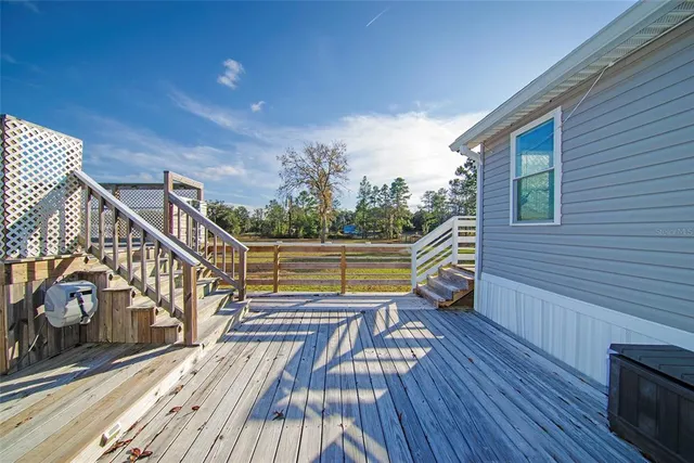 a view of a roof deck with wooden floor and fence