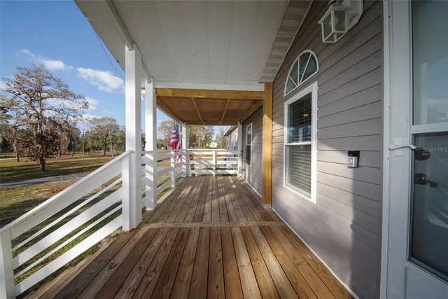 a view of balcony with wooden floor