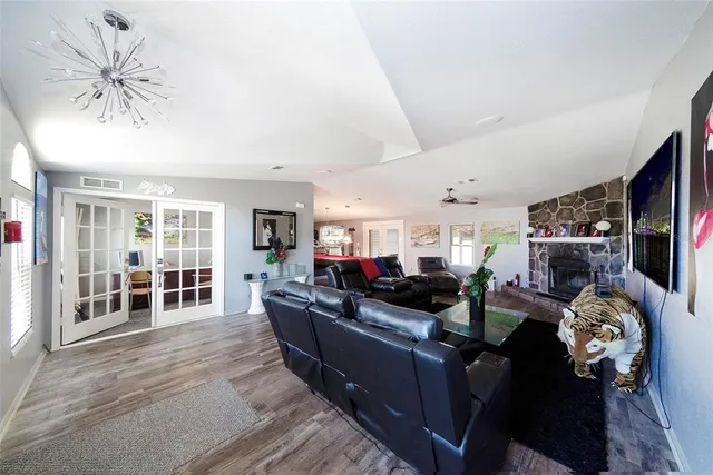 a living room with furniture a flat screen tv and a large window