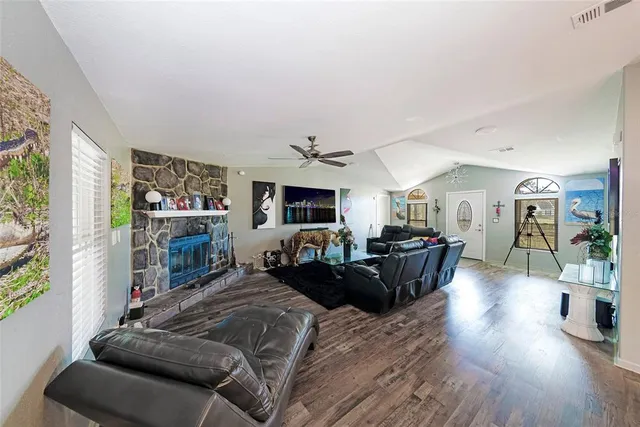 a living room with furniture fireplace and flat screen tv