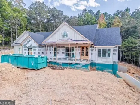 a view of a house with a yard and potted plants