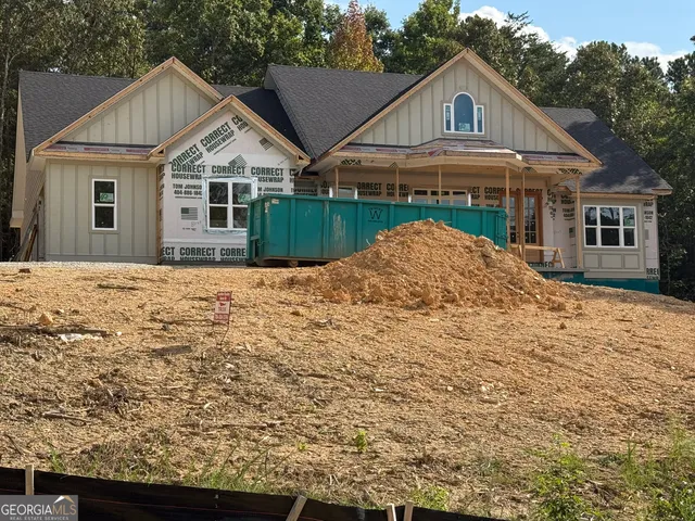 a view of house with yard and green space