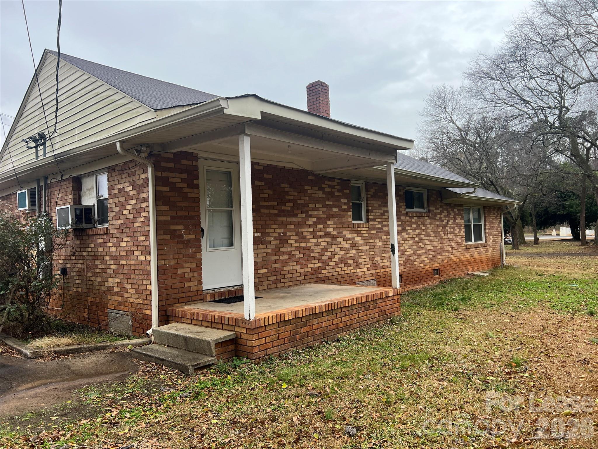 4816 South New Hope Road, Unit B Belmont, NC 28012 - Photo 2 of 13 front view of a house with a yard