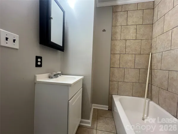 a bathroom with a sink and mirror