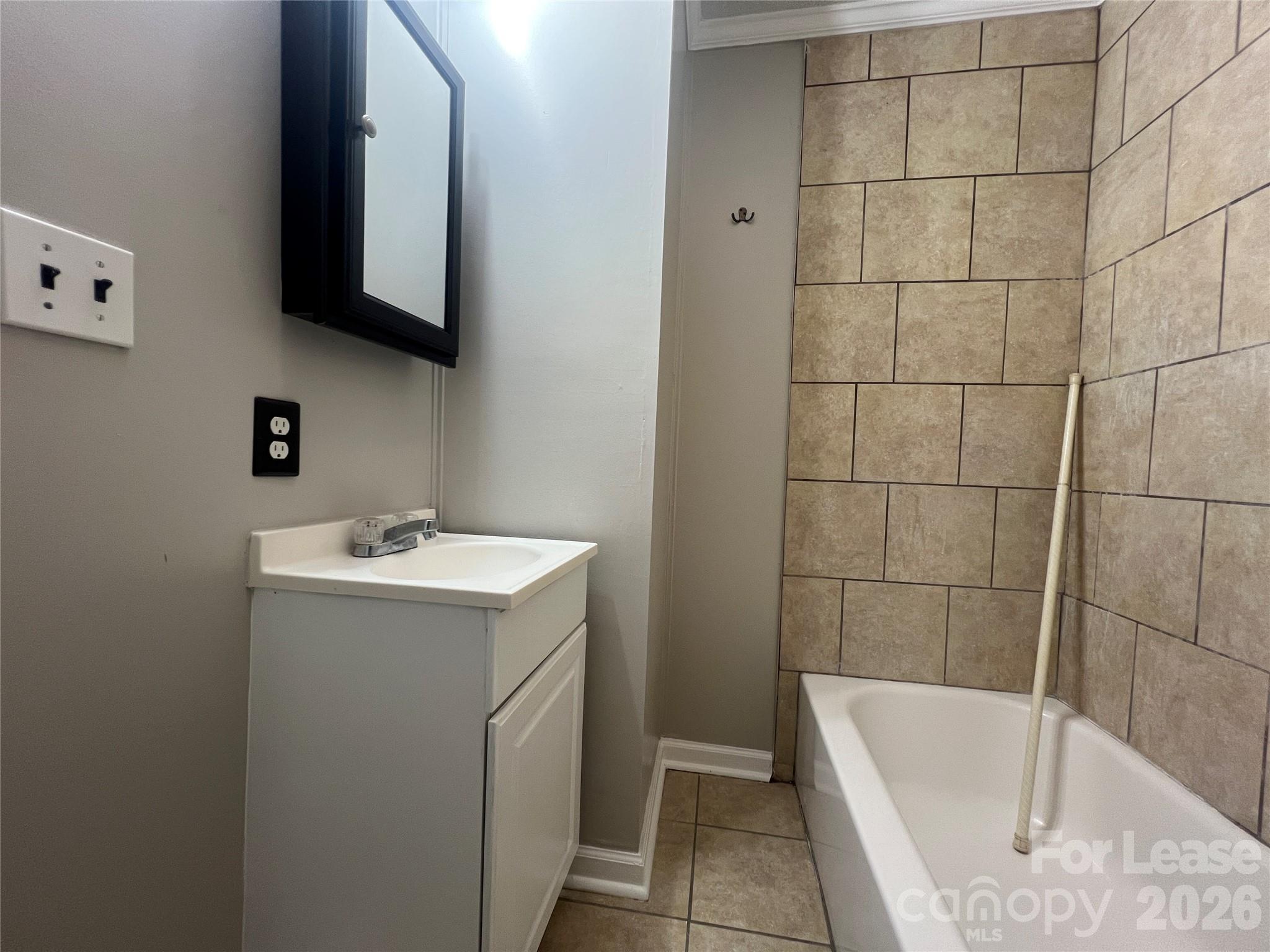 4816 South New Hope Road, Unit B Belmont, NC 28012 - Photo 10 of 13 a bathroom with a sink and mirror