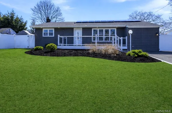 a view of a house with a yard and sitting area